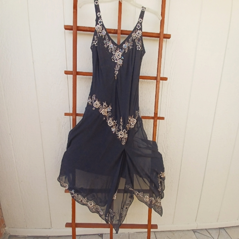 R&M Richard's.  Size small.  Black silky material with flowered embroidery.